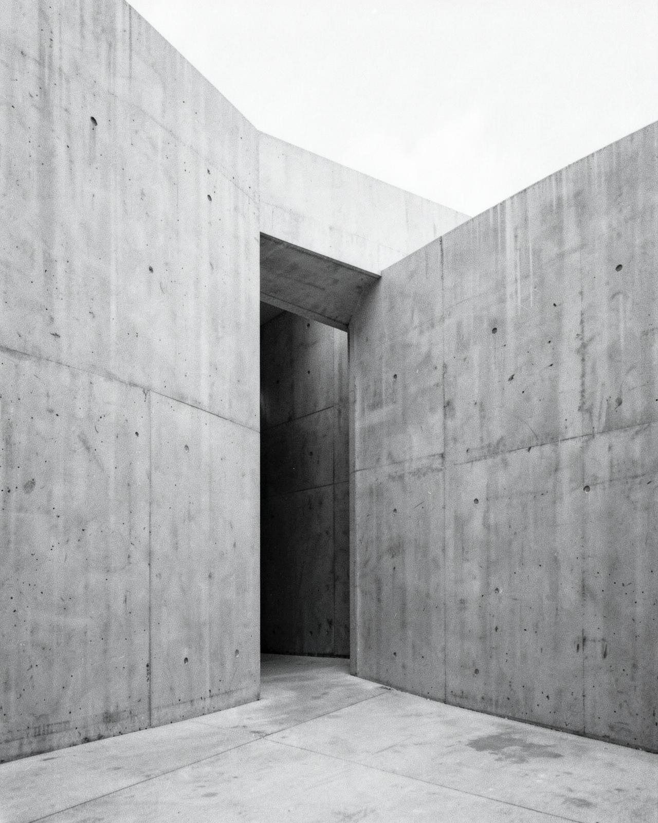 Minimal brutalist concrete structure with clean geometry and perspective
