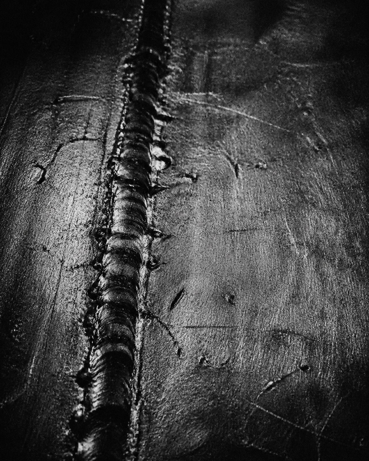 Close-up of a welded blackened steel plate
